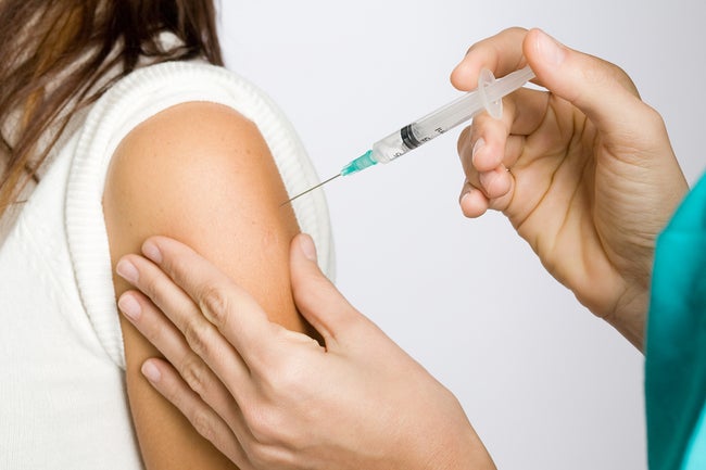 Nurse putting an injection in the arm